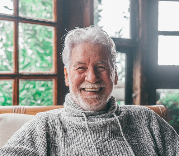 Older man smiling with dentures