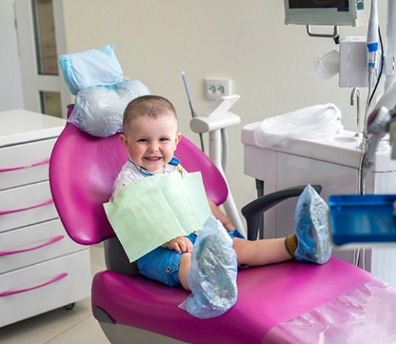 Little boy sitting in dental chair for Age One Visit in Wilmington, IL